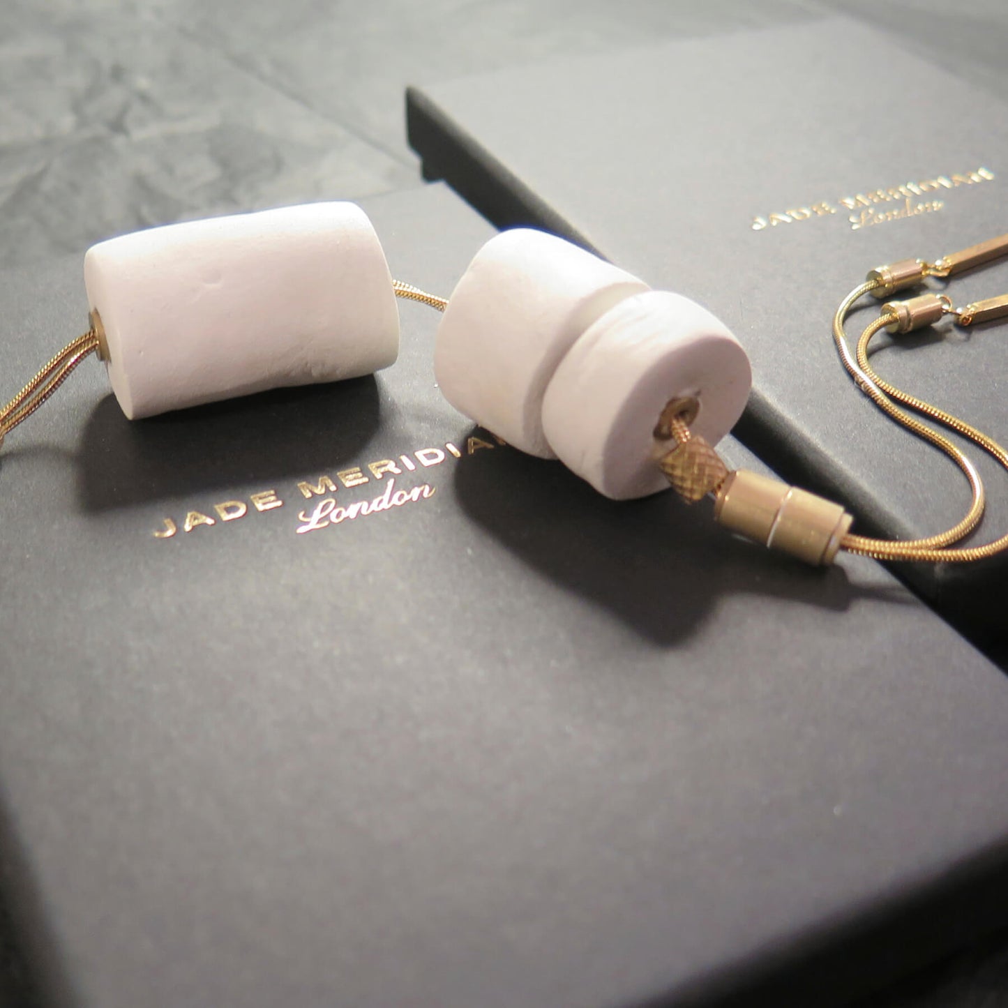 Stacked white stone tubular beads on adjustable gold snake chain necklace with brass detailing
