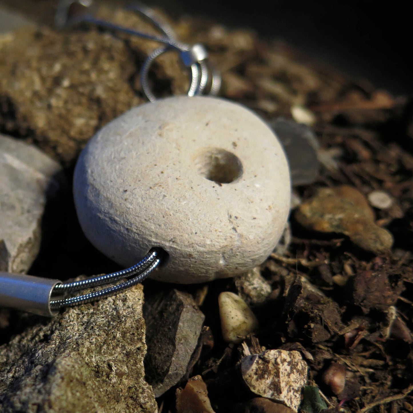 Sculpted light grey pebble on adjustable length silver snake chain necklace with bar pendant ends