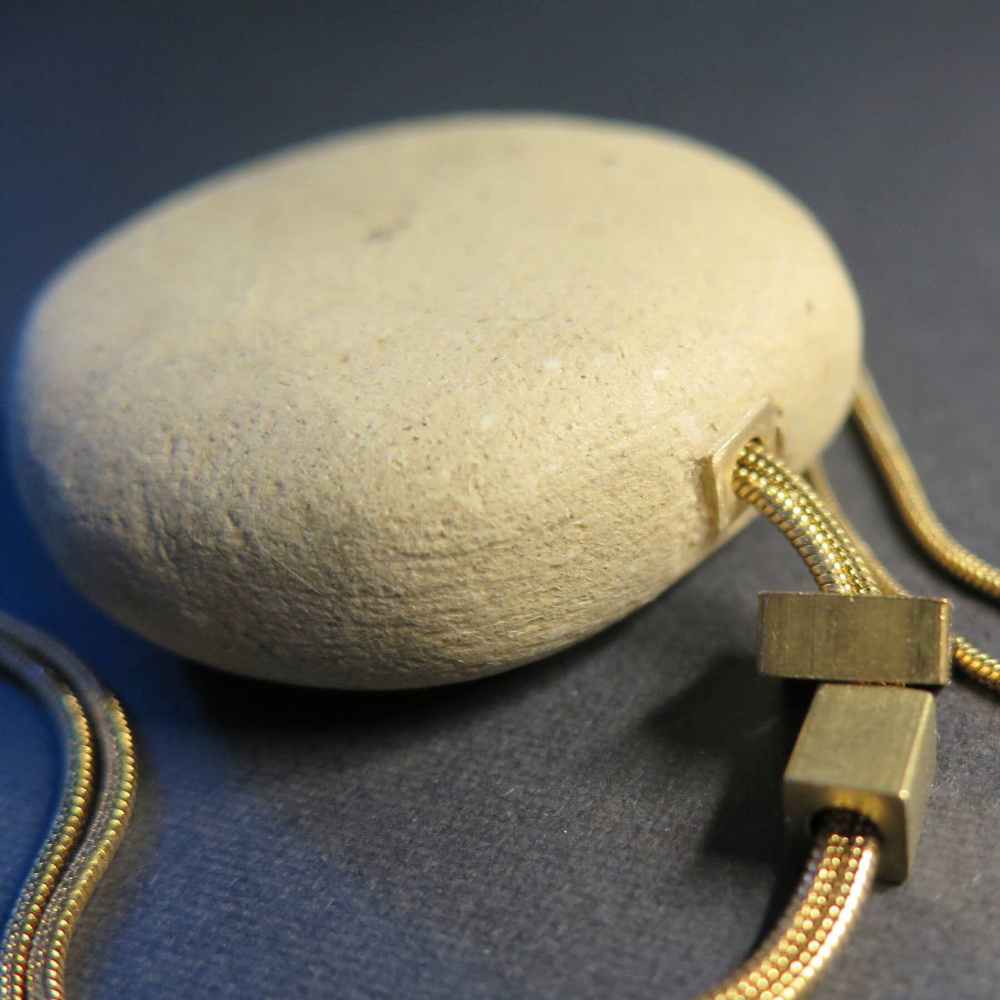 Natural sculpted pebble | Adjustable gold snake chain necklace with brass detailing