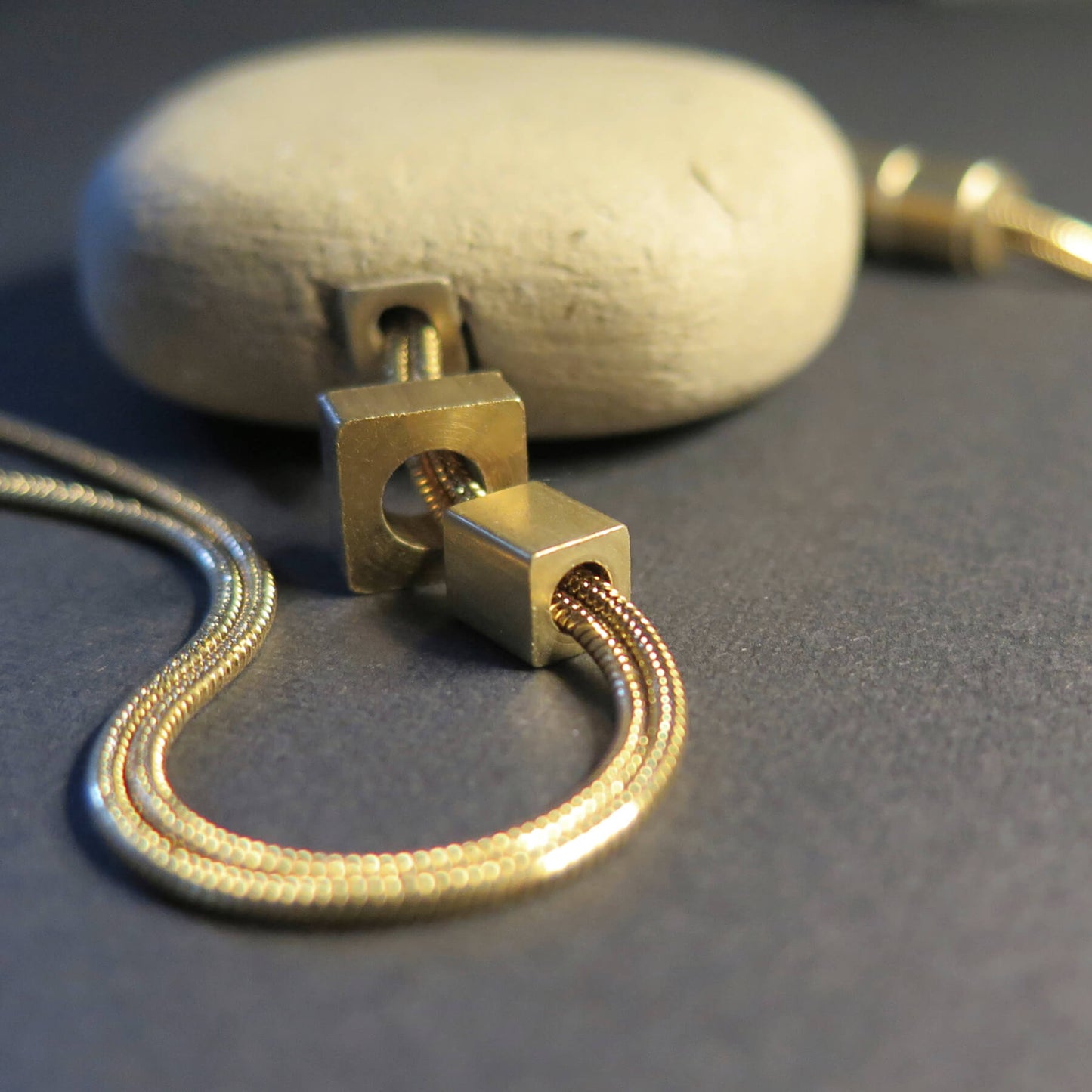 Natural sculpted pebble | Adjustable gold snake chain necklace with brass detailing