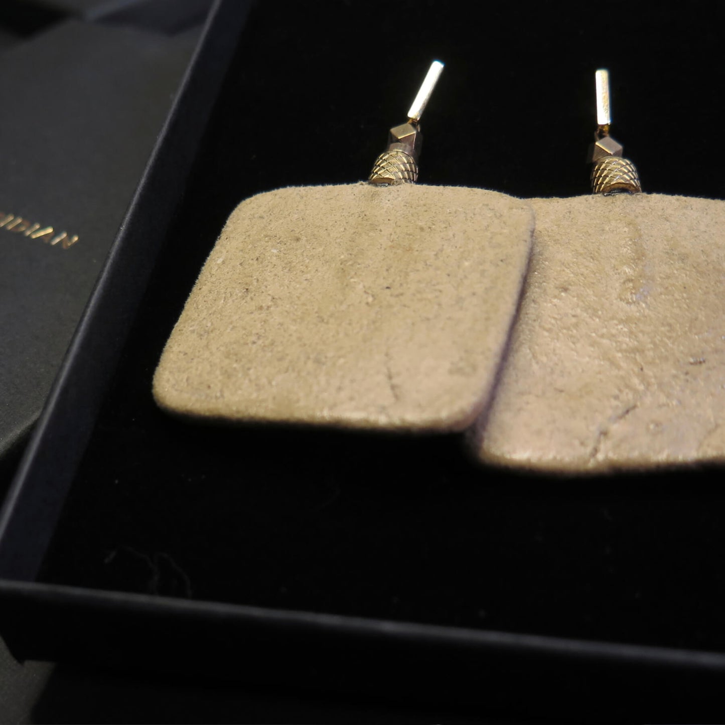 Natural stone slab earrings with brass pineapple detailing