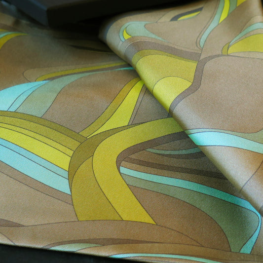 Image of a silk scarf with an original design in acid yellow, lime greens, blues, khaki and rich golds 1