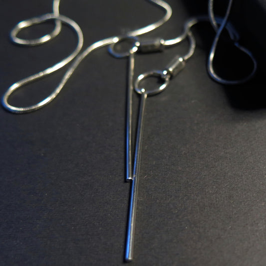 Sculpted light grey pebble on adjustable length silver snake chain necklace with bar pendant ends
