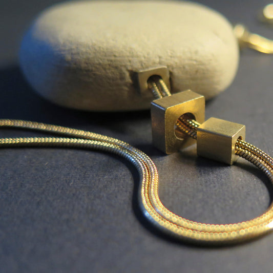 Natural sculpted pebble | Adjustable gold snake chain necklace with brass detailing